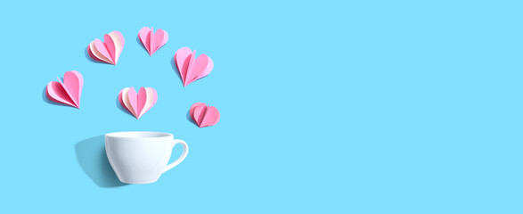 Coffee cup with paper craft hearts - flat lay