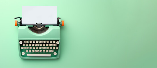 Light green typewriter on a light green background. Concept of creativity. Place for text, banner