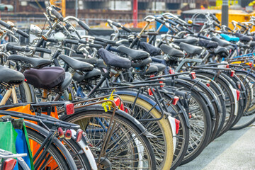 Fototapeta na wymiar Many Bicycles in a Parking Lot in Amsterdam