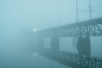 Train approaching on the Amtrak Susquehanna River Bridge on a foggy evening in Havre de Grace, Maryland