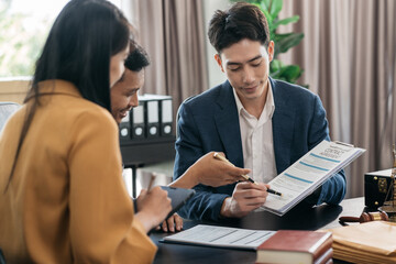 Business people and lawyers discussing contract papers sitting in the table at office in the...