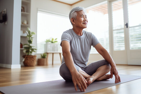 Mature asian man exercising at home, yoga for seniors, promoting physical well-being