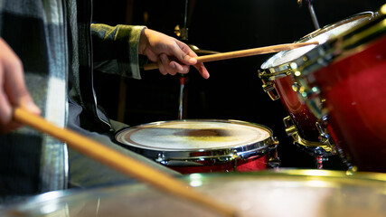 Close-up of male hands playing the drums.