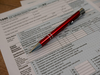 The pen is lies on the tax form 1040 U.S. Individual Income Tax Return. The time to pay taxes.