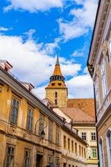 A Vibrant City Street with Majestic Buildings and an Enchanting Clock Tower. A street with buildings and a clock tower in the background