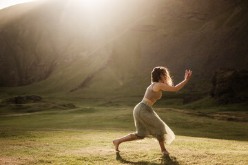 Fototapeta na wymiar Girl dancing at sunset in Iceland