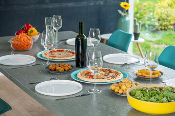 This image captures a laid-back outdoor dining scene, featuring an array of dishes ready to be...