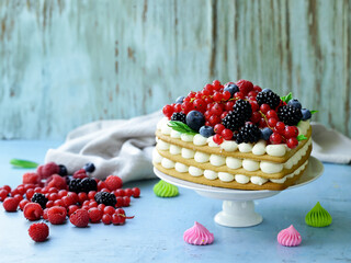 festive cake with cream and fresh berries