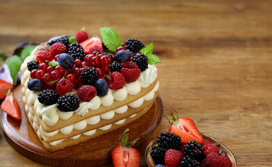 festive cake with cream and fresh berries