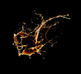 A splash of gold water. A spiral of water with splashes on a black background.
