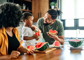 child family kitchen food boy son father mother watermelon fruit slice summer organic meal fun...