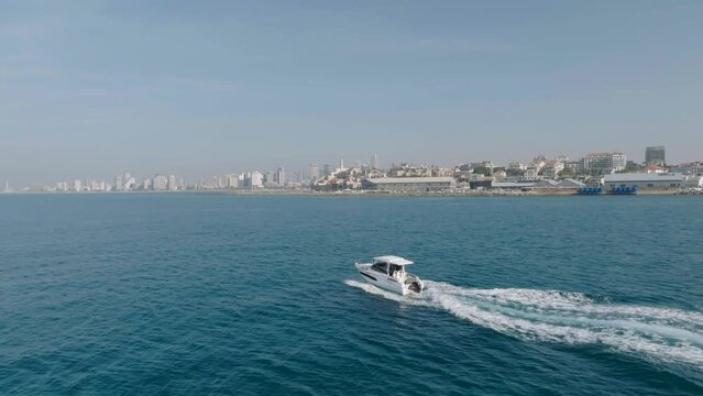 Aerial footage of A Motorboat sails off the coast of Jaffa, Tel Aviv