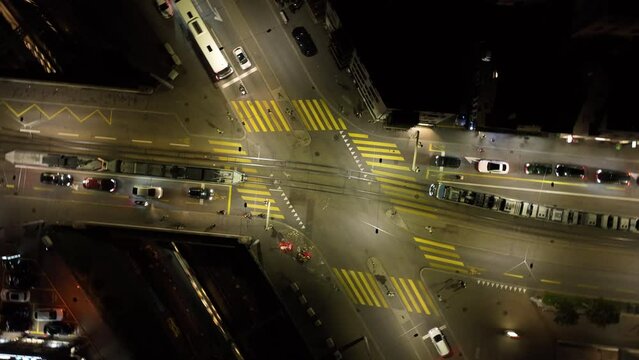 night time flight over zurich city center traffic street crossroad aerial topdown panorama 4k switzerland 
