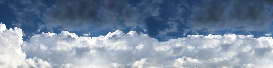 Panoramic background of a heavenly landscape with thunderclouds of sunlight. Banner.