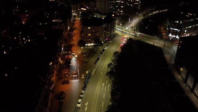night illuminated flight over zurich city tram traffic street crossroads aerial topdown panorama 4k switzerland 