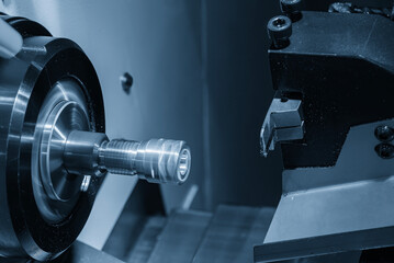 The  multi tasking CNC lathe machine swiss type slot cutting the brass fitting parts.