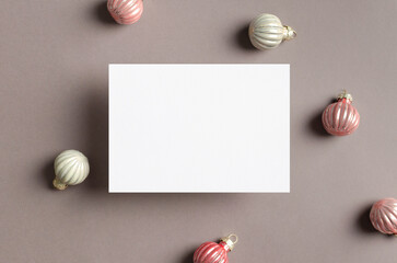 Blank greeting or invitation card mockup with winter holidays decor, top view with copy space