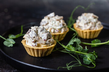 Dough tartlets with pate, mushrooms and salmon