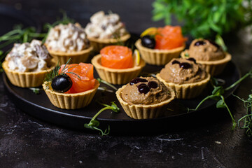 Dough tartlets with pate, mushrooms and salmon