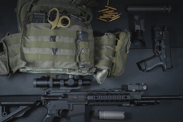 Tactical equipment, plate carrier, ar15 rifle with optical sight, pistol and night vision equipment.