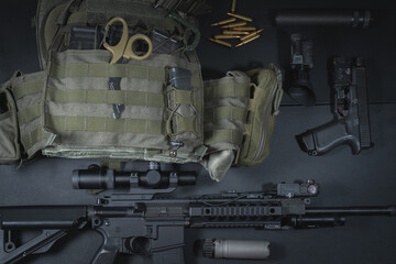 Tactical equipment, plate carrier, ar15 rifle with optical sight, pistol and night vision equipment.