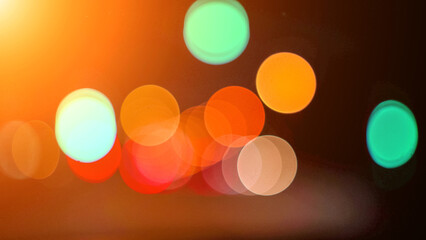 Blurred lights evening city traffic bokeh. Defocused night city traffic. Blurred lights bokeh car headlights driving evening city road. City night traffic background