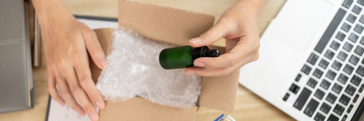 Packing box, Top view of products being packed into postal boxes for delivery to customers, Sell...