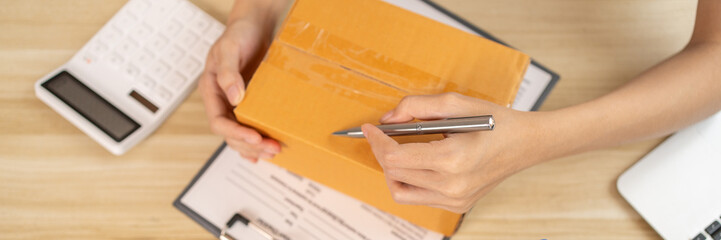 Sell products online, Top view of handwritten notes of customer details and address on postal box...
