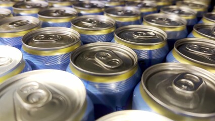 many cans of beer on the shelf in the supermarket. problem of alcoholism in the world. beer in cans for relaxing in the evening on the weekend. soda in cans at the supermarket lifestyle