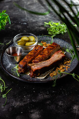 Grilled sausage on a dark plate with sauce