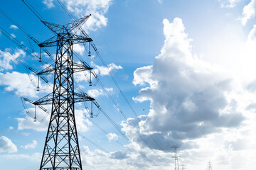 Power pylons and high-voltage lines against the background of the cloudy sky, power lines.