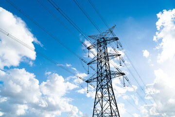 Power pylons and high-voltage lines against the background of the cloudy sky, power lines.