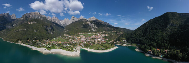 Aerial view of Lake Molveno, north of Italy in the background the city of Molveno, Alps, blue sky,...