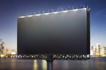 Blank black horizontal billboard on cityscape background at night, perspective view. Mockup,...