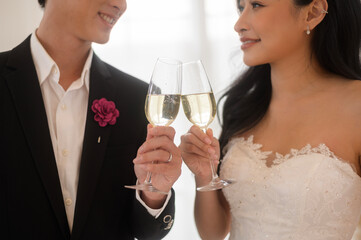 Bride and groom holding glasses of champagne at the wedding ceremony