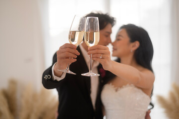 Bride and groom holding glasses of champagne at the wedding ceremony