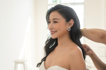 Beautiful bride doing makeup and hairstyle on ceremony wedding day