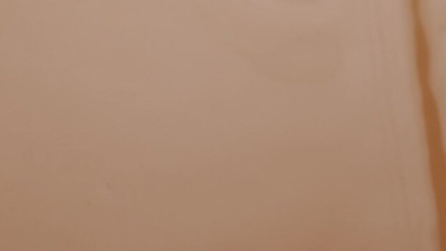 Glossy cosmetic texture, beige liquid foundation or concealer as beauty make-up product