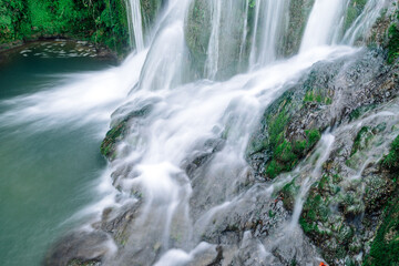 Fototapeta premium Silky effect waterfalls inside the village of Torbera, Burgos, Castile and Leon, Spain.