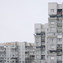 Facade of a grey multi-storey soviet panel building