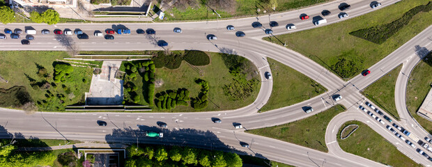 Top down view of busy street intersection with moving cars traffic. View of traffic jam passing...