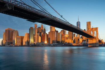 Classic view of Manhattan under Brooklyn Bridge at sunrise