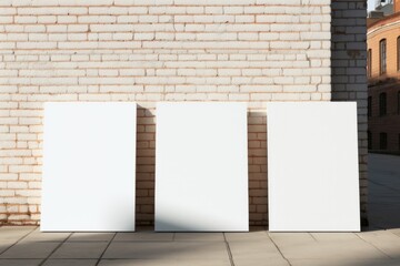 Three empty advertising billboards on the wall of building