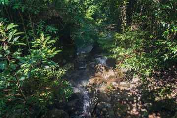 Erawan National Park in Thailand. Erawan Waterfall is a popular tourist destination and famous for its emerald blue water. Deep forest in tropical climate with fantasy atmosphere.