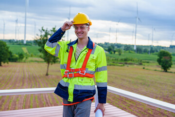 Portrait of Technician engineer worker builders looking for wind turbine blueprint drawings for wind turbine construction at windmill field farm. Alternative renewable energy