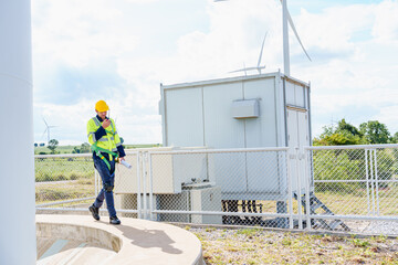 Technician engineer caucasian Man working and maintenance with wind turbine blueprint drawing of wind turbines at windmill field farm. Alternative renewable energy for clean energy concept.