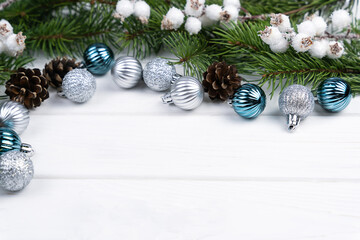 Christmas festive background with fir branches and Christmas tree decorations. Top view. Close-up. Copy space.