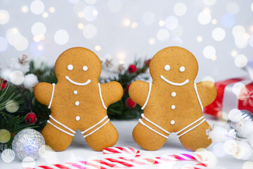 Gingerbread men and glass of milk on the Christmas table. Traditional Christmas treat for Santa. Close-up.
