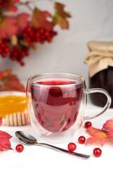 Vitamin healthy tea from viburnum berries on the table. Close-up. Selective focus.