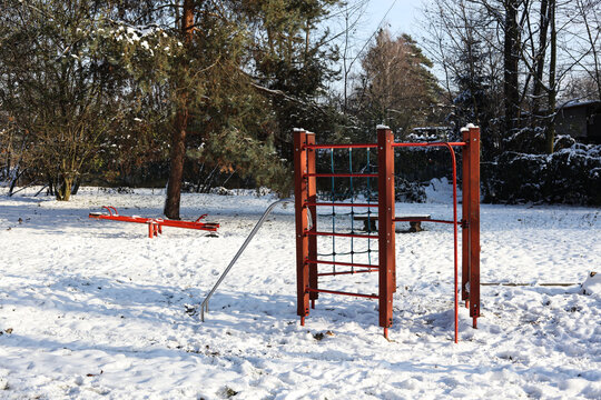 winter landscape with a kids playground covered in snow 
